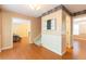 Hallway features hardwood floors, chair rail, decorative wallpaper, and staircase at 5425 Windswept Trce, Sugar Hill, GA 30518