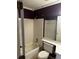 Bathroom with a white tiled shower, neutral flooring, and a purple accent wall at 621 Ridge Creek Dr, Clarkston, GA 30021