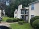 Beige two-story condo with black balcony railing and manicured front lawn at 621 Ridge Creek Dr, Clarkston, GA 30021
