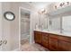 Bathroom features double sinks, wood cabinets and shower/tub combination at 1070 Cureton Dr, Austell, GA 30106