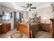 Bedroom with ceiling fan, mounted TV, and rich, dark wood furniture at 1070 Cureton Dr, Austell, GA 30106
