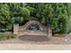 Burton Woods community sign surrounded by lush evergreen trees at 1070 Cureton Dr, Austell, GA 30106