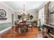 Formal dining room with hardwood floors, chandelier, decorative wall art, and ample seating for gatherings at 1070 Cureton Dr, Austell, GA 30106