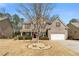 Traditional two-story home with brick facade, landscaped front yard, and driveway leading to a two-car garage at 1070 Cureton Dr, Austell, GA 30106