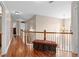 Open second-floor hallway with hardwood floors and decorative bench seating at 1070 Cureton Dr, Austell, GA 30106