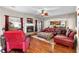 Comfortable living room with fireplace, leather seating, hardwood floors, and seamless flow to the kitchen at 1070 Cureton Dr, Austell, GA 30106