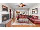 Inviting living room featuring a fireplace, hardwood floors, leather furniture, and an open floor plan at 1070 Cureton Dr, Austell, GA 30106