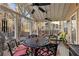 Inviting covered patio with ceiling fans, outdoor seating, and views of the wooded backyard at 1070 Cureton Dr, Austell, GA 30106