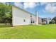 Back exterior view showing a large grassy yard, and chimney at 11827 Spring Lake Way, Fayetteville, GA 30215