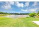 Expansive, well-maintained backyard offering serene water views and a lush green lawn at 11827 Spring Lake Way, Fayetteville, GA 30215
