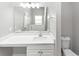 Bathroom featuring double sink vanity with white cabinets, light countertop, and large mirror at 11827 Spring Lake Way, Fayetteville, GA 30215
