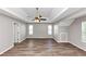 Open bedroom with hard surface floors, trey ceiling with fan, and large windows at 11827 Spring Lake Way, Fayetteville, GA 30215