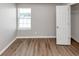 Cozy bedroom with hardwood floors, a window for natural light, and a closet at 11827 Spring Lake Way, Fayetteville, GA 30215