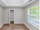 Bright bedroom featuring hardwood floors, a window for natural light, and an open closet at 11827 Spring Lake Way, Fayetteville, GA 30215
