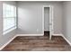 Bedroom with natural light, hardwood floors, a window with horizontal blinds, and a closet at 11827 Spring Lake Way, Fayetteville, GA 30215
