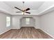 Spacious bedroom with trey ceiling, ceiling fan, recessed lights, and wood-look flooring at 11827 Spring Lake Way, Fayetteville, GA 30215