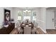 Bright dining room with bay window, chandelier, gray walls, and wood-look floors at 11827 Spring Lake Way, Fayetteville, GA 30215