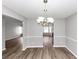 Open dining room area featuring modern chandelier and light wood flooring at 11827 Spring Lake Way, Fayetteville, GA 30215