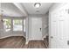 Inviting foyer with new wood flooring, staircase, a light fixture and a front door at 11827 Spring Lake Way, Fayetteville, GA 30215