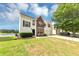 Charming two-story home featuring a brick facade, white siding, a two-car garage, and water view at 11827 Spring Lake Way, Fayetteville, GA 30215