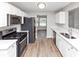 Modern kitchen with stainless steel appliances, quartz countertops and ample cabinet space at 11827 Spring Lake Way, Fayetteville, GA 30215