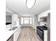 Bright kitchen showcasing stainless appliances, quartz countertops, and ample cabinet space at 11827 Spring Lake Way, Fayetteville, GA 30215