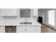 Kitchen with quartz countertops, stainless steel dishwasher, and backyard access at 11827 Spring Lake Way, Fayetteville, GA 30215