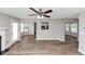 Open living room with hardwood floors, natural light, and seamless flow to the kitchen at 11827 Spring Lake Way, Fayetteville, GA 30215