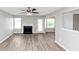 Spacious living room with a fireplace, ceiling fan, and backyard access at 11827 Spring Lake Way, Fayetteville, GA 30215