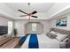 Staged main bedroom with trey ceiling and fan, hard surface flooring, and neutral paint at 11827 Spring Lake Way, Fayetteville, GA 30215