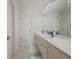 Bright bathroom featuring a long vanity, large mirror, and tile flooring at 1320 Kildare Ct, Snellville, GA 30078
