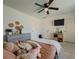 Large bedroom featuring plush carpeting, a ceiling fan, and a TV at 1320 Kildare Ct, Snellville, GA 30078