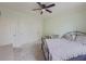 Bedroom featuring three closets, light green walls, and a ceiling fan at 1320 Kildare Ct, Snellville, GA 30078