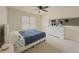 Bright bedroom featuring plush carpeting, a ceiling fan, and a large window at 1320 Kildare Ct, Snellville, GA 30078