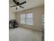 Bedroom with a ceiling fan and a window overlooking the home's grounds at 1320 Kildare Ct, Snellville, GA 30078