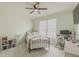 Bedroom with light green walls, a black metal bed frame, and a ceiling fan at 1320 Kildare Ct, Snellville, GA 30078