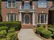 Close up of the front door with brick walkway and carefully trimmed shrubbery at 1320 Kildare Ct, Snellville, GA 30078