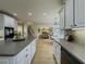 Spacious kitchen featuring an island, light wood floors, and white cabinetry at 1320 Kildare Ct, Snellville, GA 30078