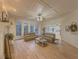 Open-concept living room with hardwood floors, coffered ceilings, and lots of natural light at 1320 Kildare Ct, Snellville, GA 30078