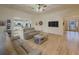 Spacious living room featuring hardwood floors, coffered ceilings, and an open floor plan leading to the kitchen at 1320 Kildare Ct, Snellville, GA 30078