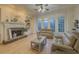 Elegant living room offering ample natural light, a fireplace, and comfortable seating arrangements at 1320 Kildare Ct, Snellville, GA 30078
