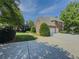 View of side exterior of home with three car garage and basketball court at 1320 Kildare Ct, Snellville, GA 30078