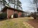Well-maintained backyard featuring lush greenery, complemented by a classic brick exterior at 1376 Woodbine St, Marietta, GA 30062