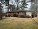 Exterior of the brick home is complemented by a well-maintained lawn and mature trees at 1376 Woodbine St, Marietta, GA 30062