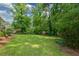Lush backyard surrounded by mature trees and greenery, offering a private outdoor space at 1376 Woodbine St, Marietta, GA 30062