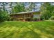 Well-maintained backyard features a lush lawn and mature landscaping providing privacy at 1376 Woodbine St, Marietta, GA 30062
