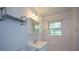 Bright bathroom featuring classic white tiles, a vanity, and a shower-tub combination at 1376 Woodbine St, Marietta, GA 30062