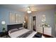 Spacious bedroom with elegant decor, modern lighting and furniture, and warm natural light at 1376 Woodbine St, Marietta, GA 30062