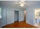 Bright bedroom with hardwood floors, ceiling fan, closet, and ensuite bathroom at 1376 Woodbine St, Marietta, GA 30062