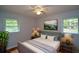 Calming bedroom with soft blue walls, a ceiling fan, and plush bedding and decor at 1376 Woodbine St, Marietta, GA 30062